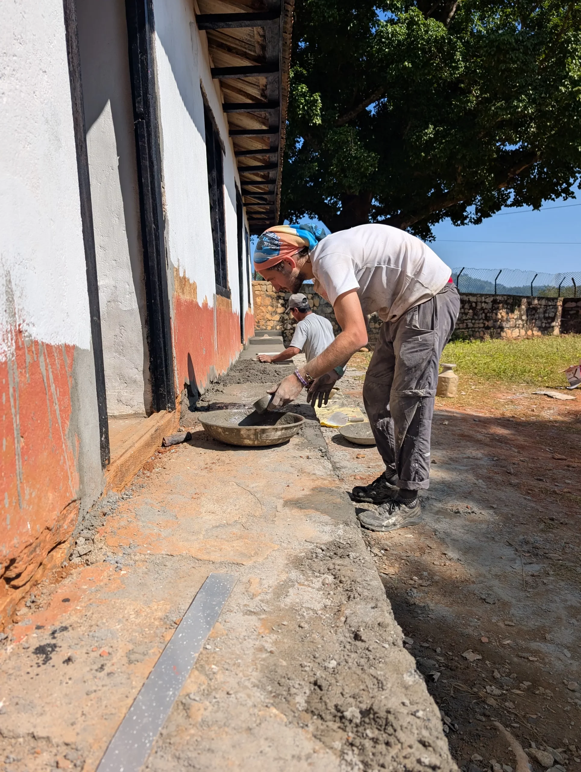 Bénévoles avec des enfants devant l’école